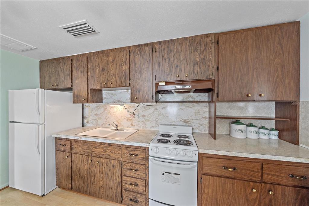 1260 Yoder Avenue Sarasota, FL 34239 - Photo 39 of 42 a kitchen with a sink a stove and cabinets