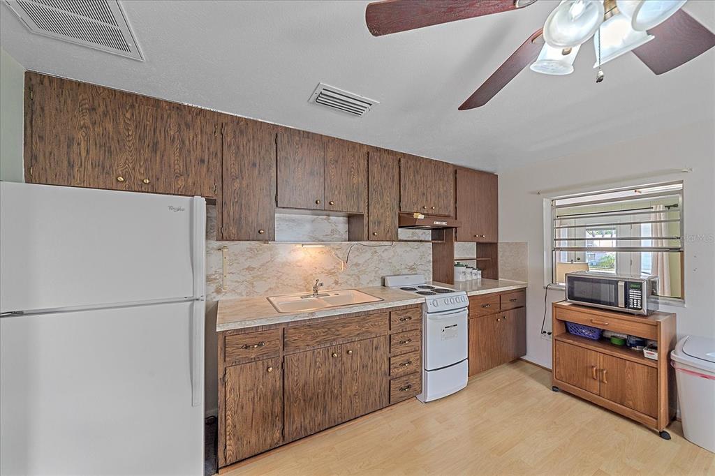 1260 Yoder Avenue Sarasota, FL 34239 - Photo 40 of 42 a kitchen with a sink a stove and refrigerator