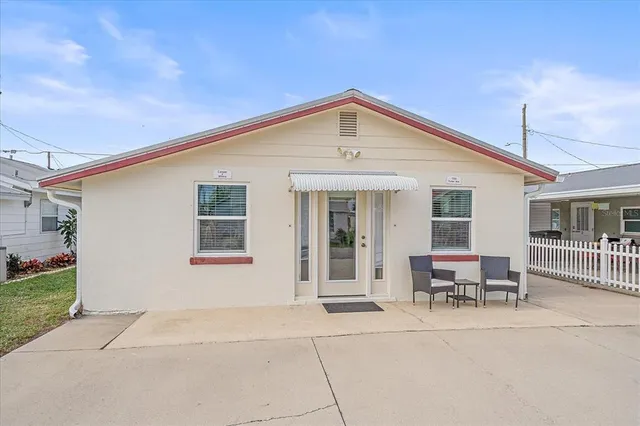 a view of a house with patio and a yard