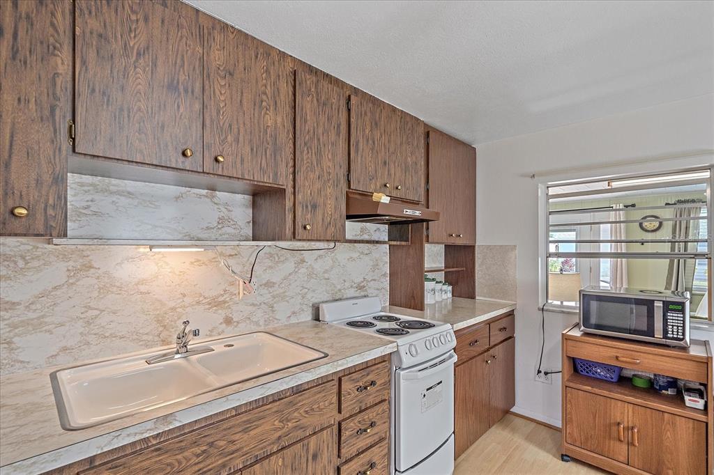 1260 Yoder Avenue Sarasota, FL 34239 - Photo 41 of 42 a kitchen with a sink stove and cabinets