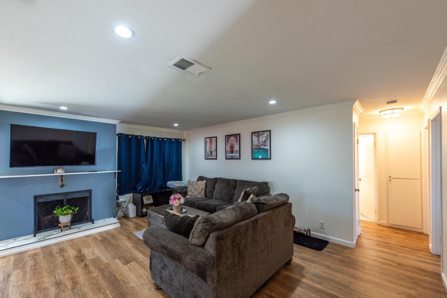 5798 Ribchester Court San Jose, CA 95123 - Photo 2 of 18 a living room with furniture a flat screen tv and a fireplace