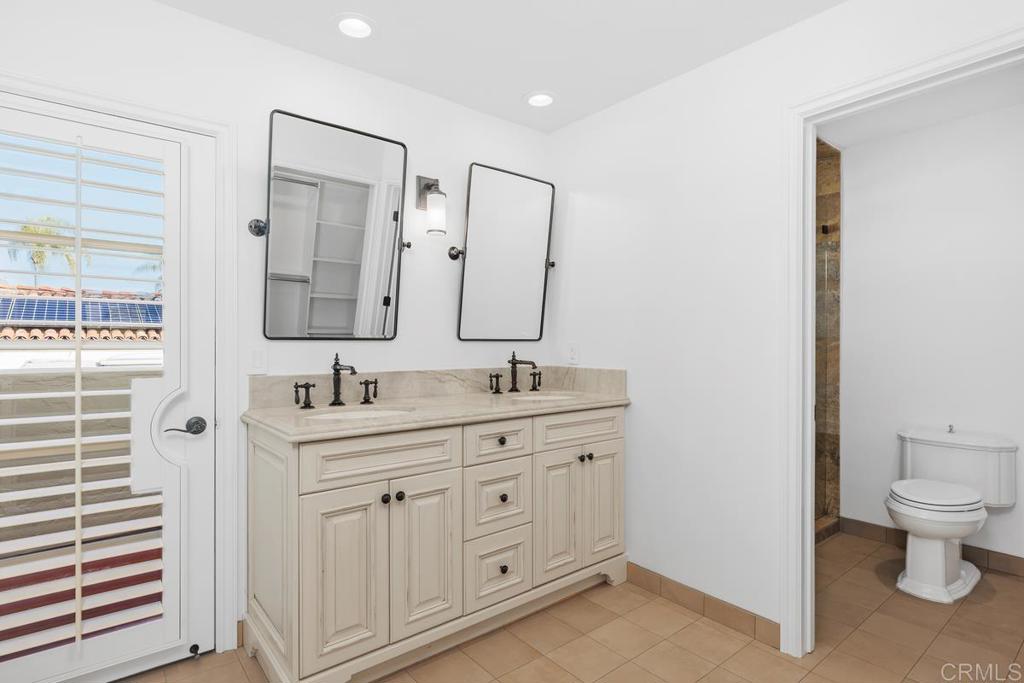 6125 La Flecha Rancho Santa Fe, CA 92067 - Photo 12 of 20 a bathroom with a toilet a sink a mirror and a shower