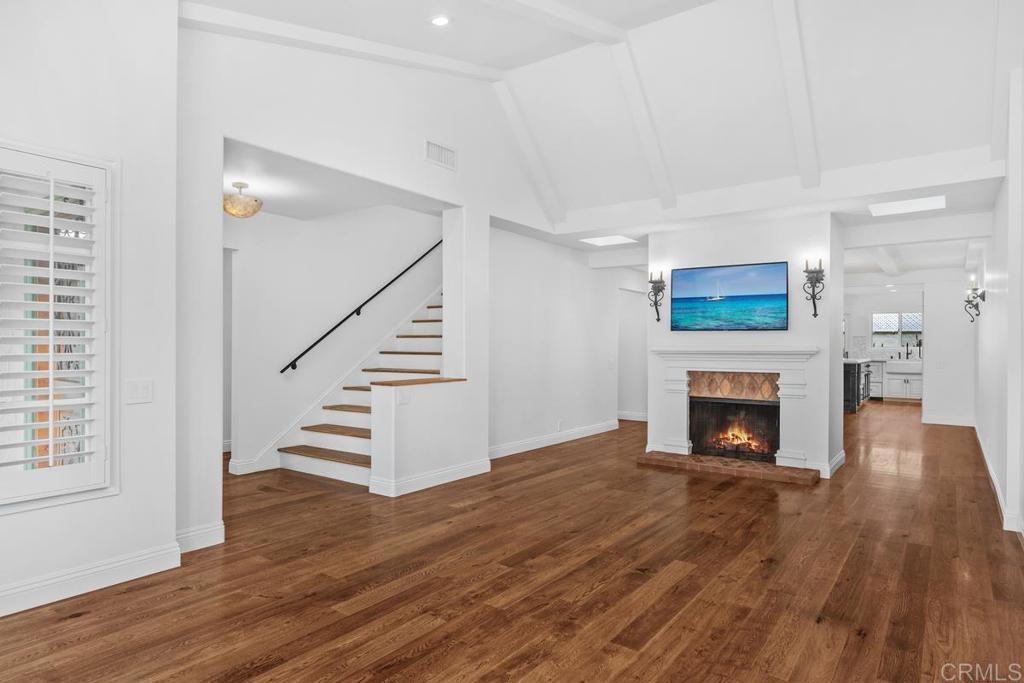 6125 La Flecha Rancho Santa Fe, CA 92067 - Photo 4 of 20 a view of an empty room with wooden floor fireplace and a window