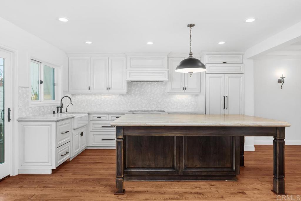 6125 La Flecha Rancho Santa Fe, CA 92067 - Photo 5 of 20 a kitchen with kitchen island granite countertop a sink cabinets and wooden floor