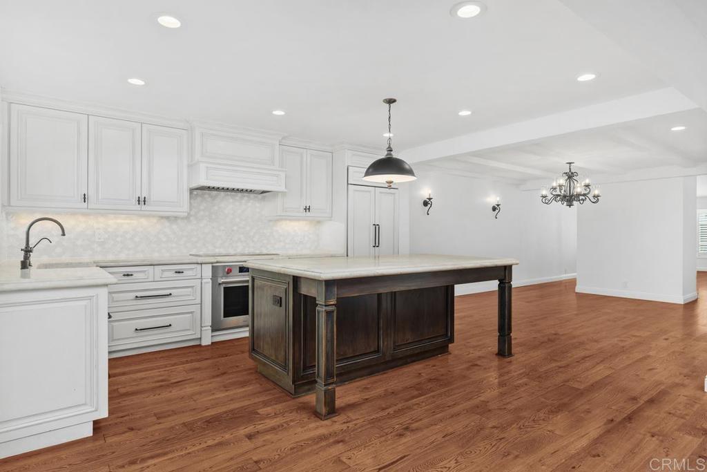6125 La Flecha Rancho Santa Fe, CA 92067 - Photo 7 of 20 a kitchen with stainless steel appliances a sink stove and wooden floor