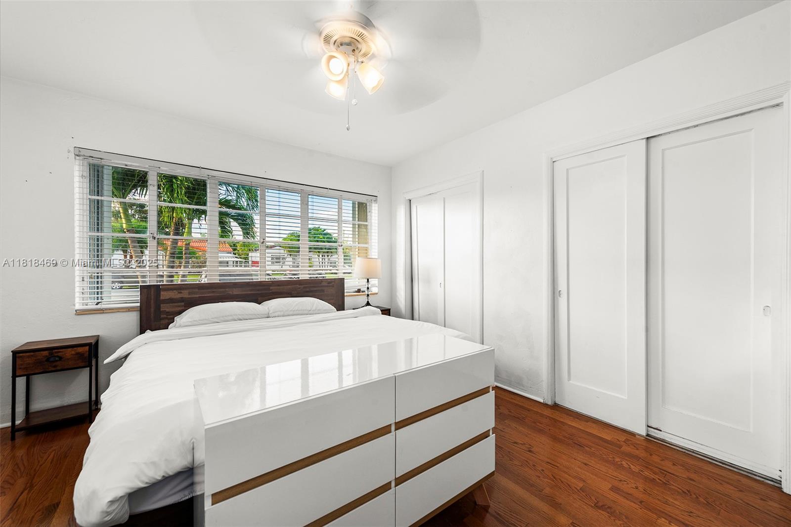 1545 Normandy Drive Miami Beach, FL 33141 - Photo 11 of 37 a bedroom with a large bed and a large window