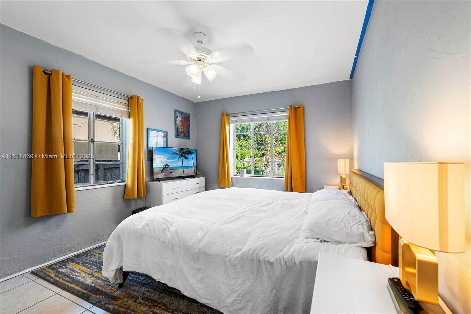 1545 Normandy Drive Miami Beach, FL 33141 - Photo 15 of 37 a bedroom with a bed and a large window with outer view