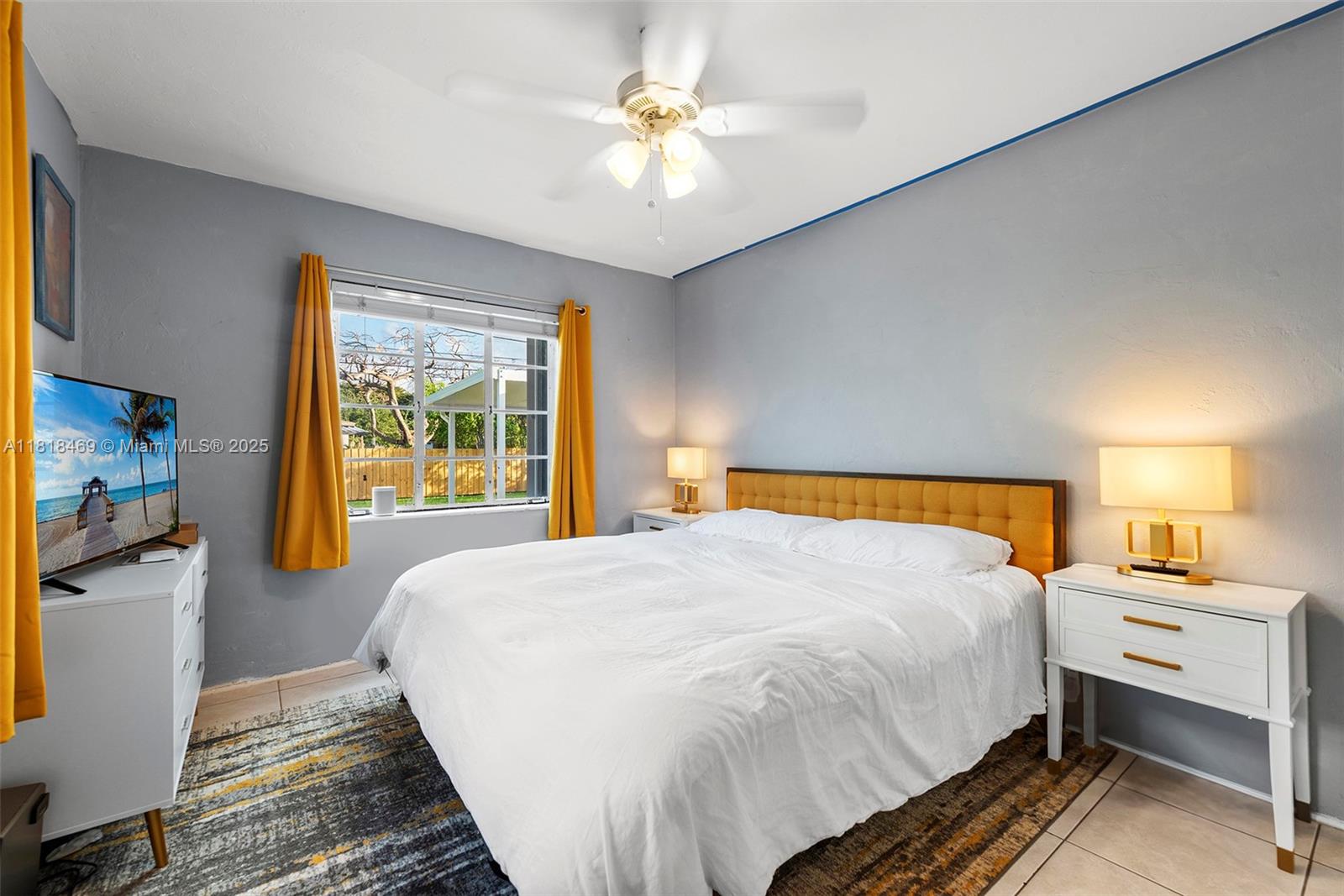 1545 Normandy Drive Miami Beach, FL 33141 - Photo 16 of 37 a bedroom with a bed and a chandelier