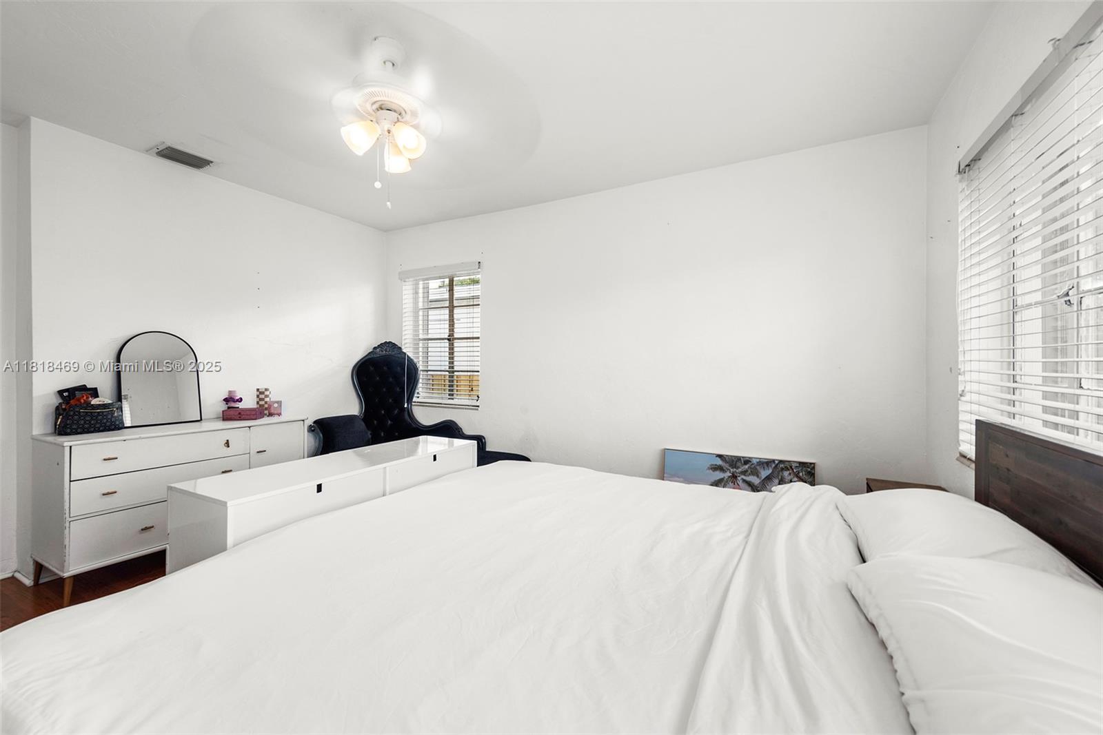 1545 Normandy Drive Miami Beach, FL 33141 - Photo 17 of 37 a bedroom with a bed and a large window