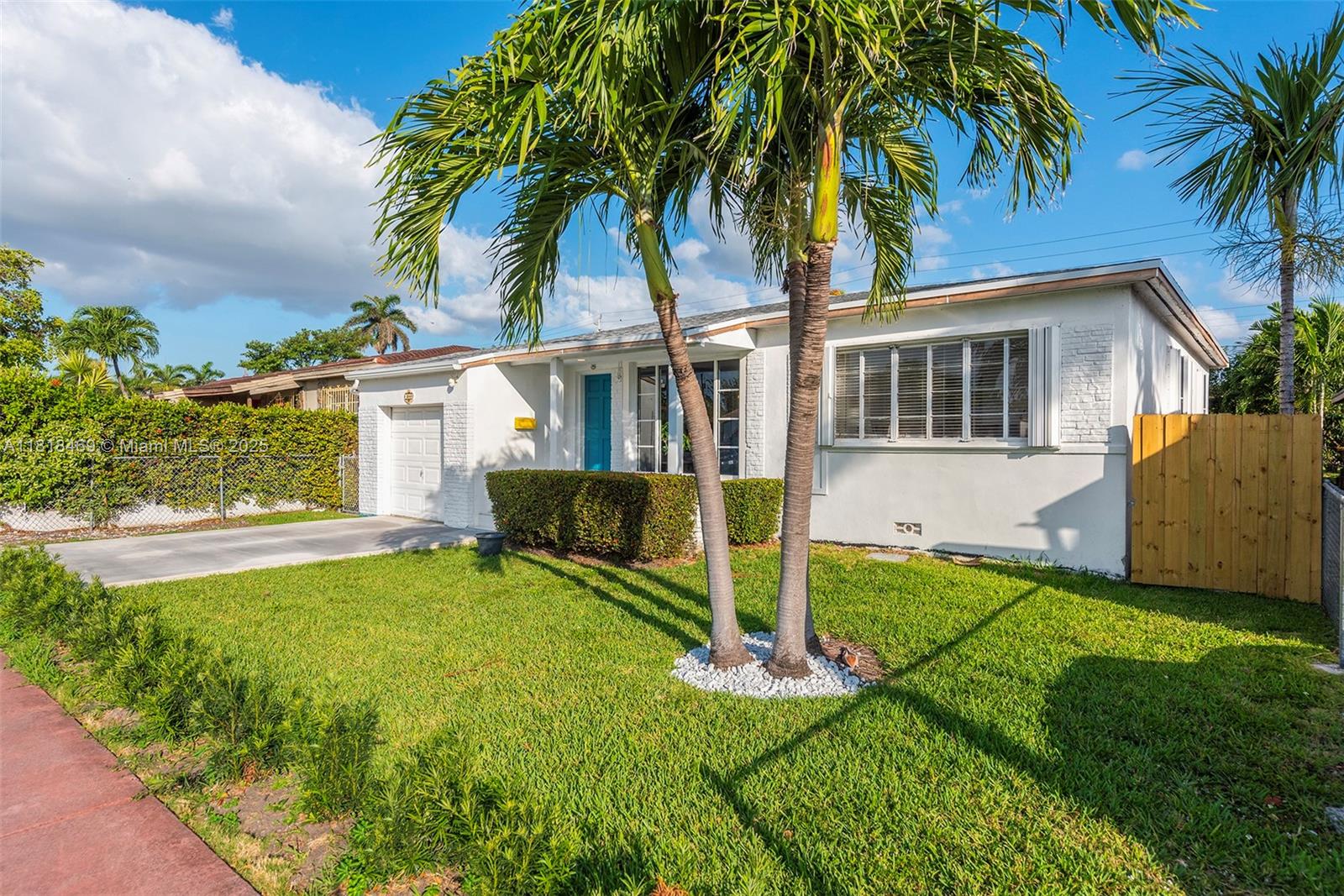 1545 Normandy Drive Miami Beach, FL 33141 - Photo 2 of 37 a view of house with a yard and palm trees