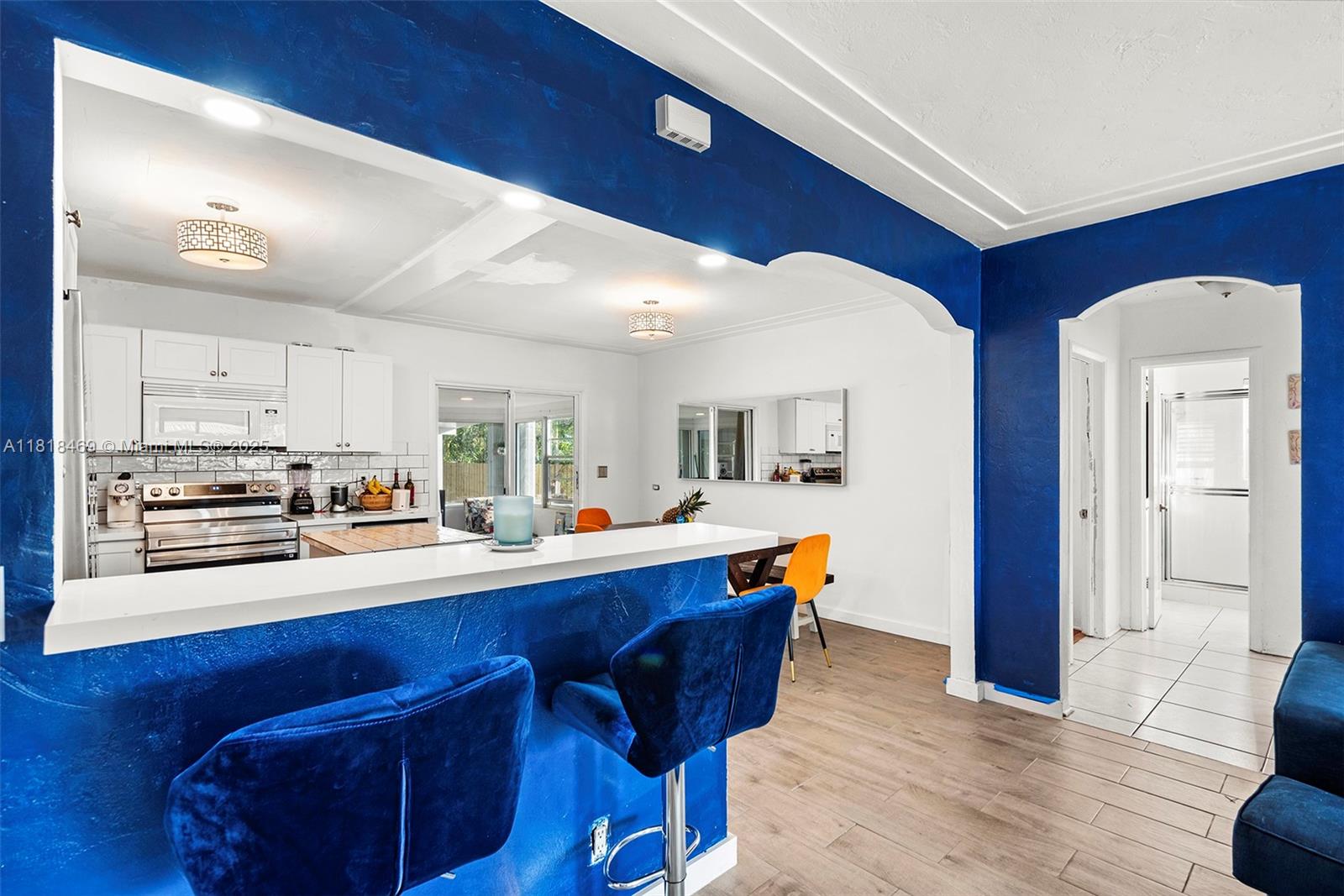 1545 Normandy Drive Miami Beach, FL 33141 - Photo 22 of 37 a kitchen with stainless steel appliances granite countertop a sink wooden cabinets and counter space
