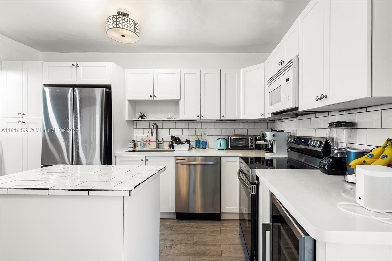 1545 Normandy Drive Miami Beach, FL 33141 - Photo 25 of 37 a kitchen with a sink a stove and refrigerator