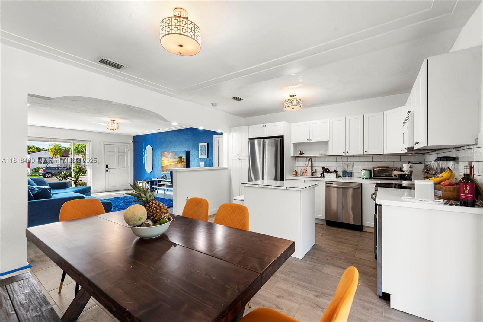 1545 Normandy Drive Miami Beach, FL 33141 - Photo 27 of 37 a large kitchen with a table chairs and a refrigerator