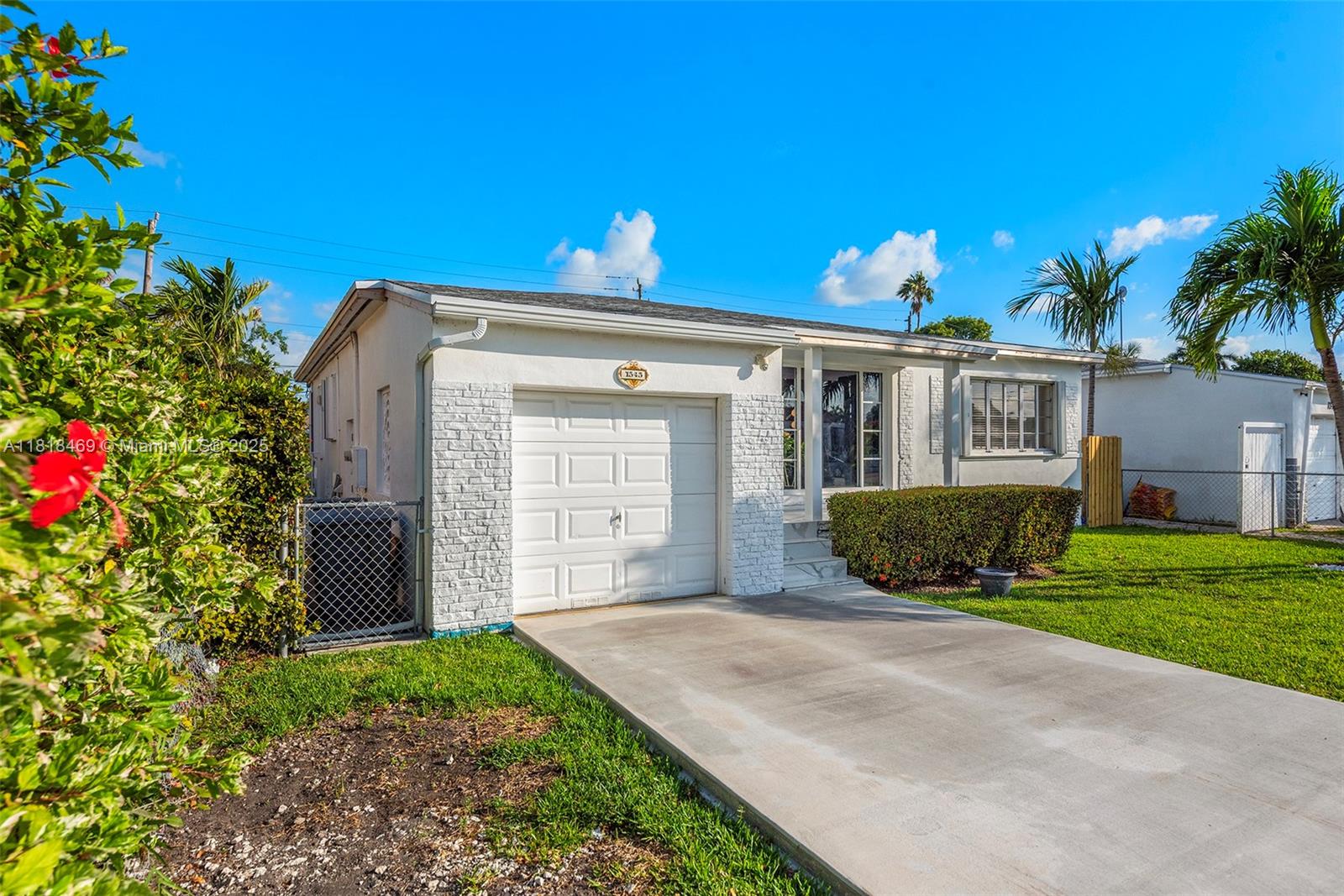 1545 Normandy Drive Miami Beach, FL 33141 - Photo 3 of 37 a front view of a house with a yard and garage