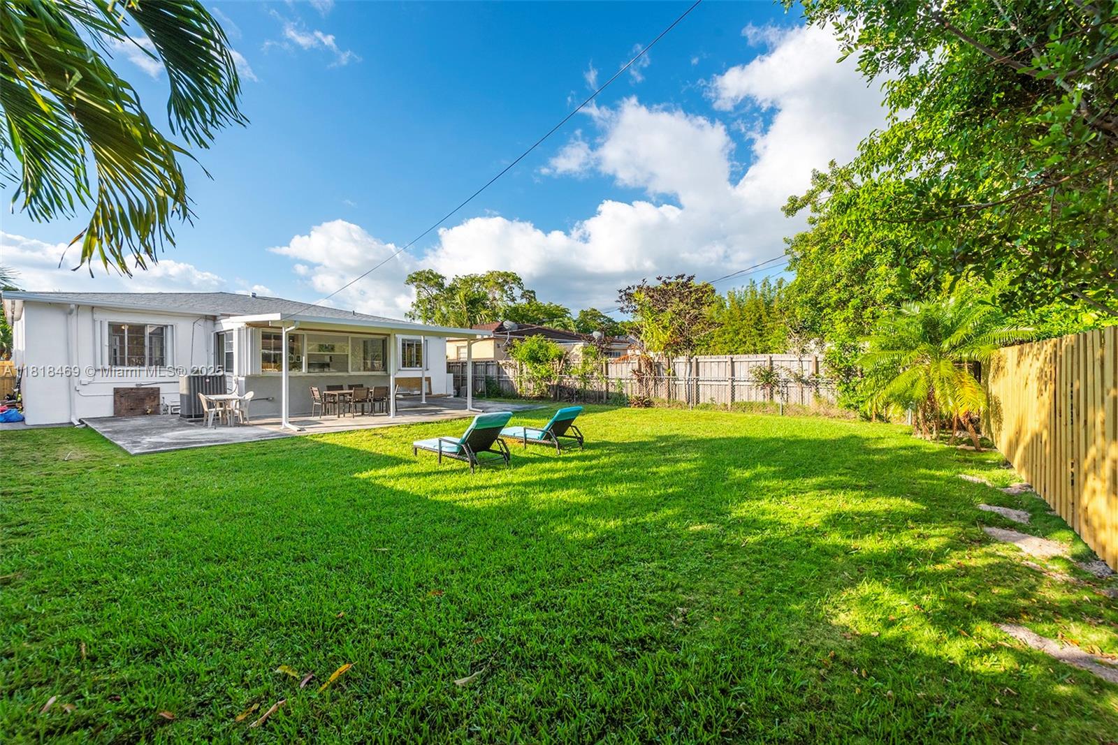 1545 Normandy Drive Miami Beach, FL 33141 - Photo 34 of 37 a view of swimming pool with lawn chairs and large trees