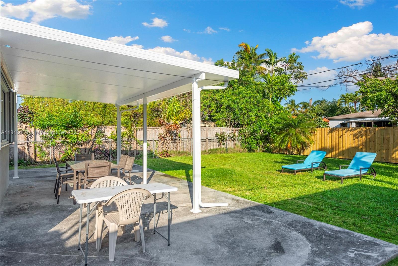 1545 Normandy Drive Miami Beach, FL 33141 - Photo 37 of 37 a view of a chair and tables in the garden