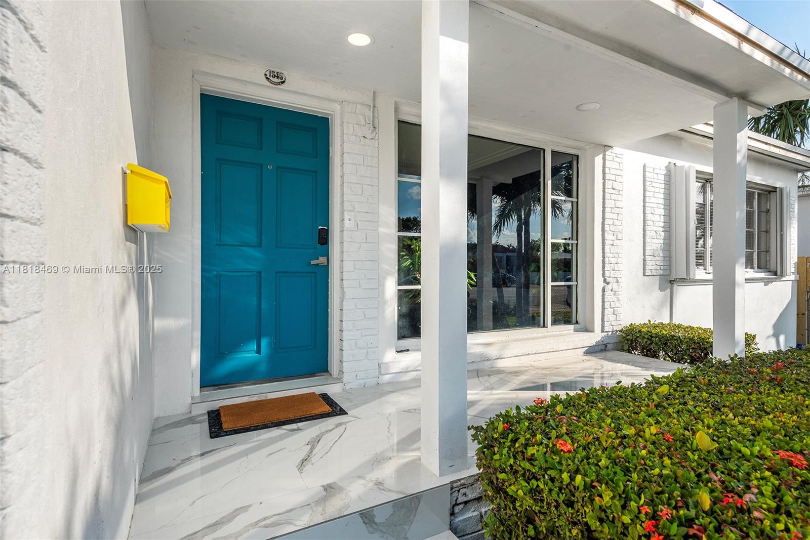 1545 Normandy Drive Miami Beach, FL 33141 - Photo 4 of 37 a front view of a house with a garden