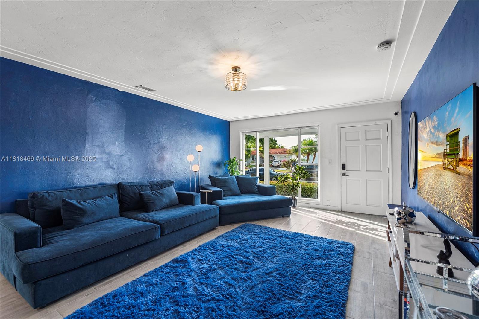 1545 Normandy Drive Miami Beach, FL 33141 - Photo 6 of 37 a living room with furniture and a flat screen tv
