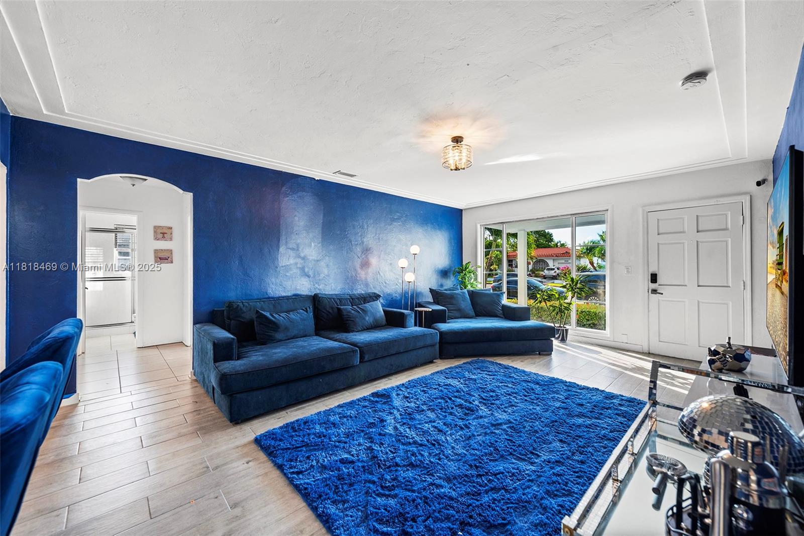 1545 Normandy Drive Miami Beach, FL 33141 - Photo 7 of 37 a living room with furniture and a fireplace