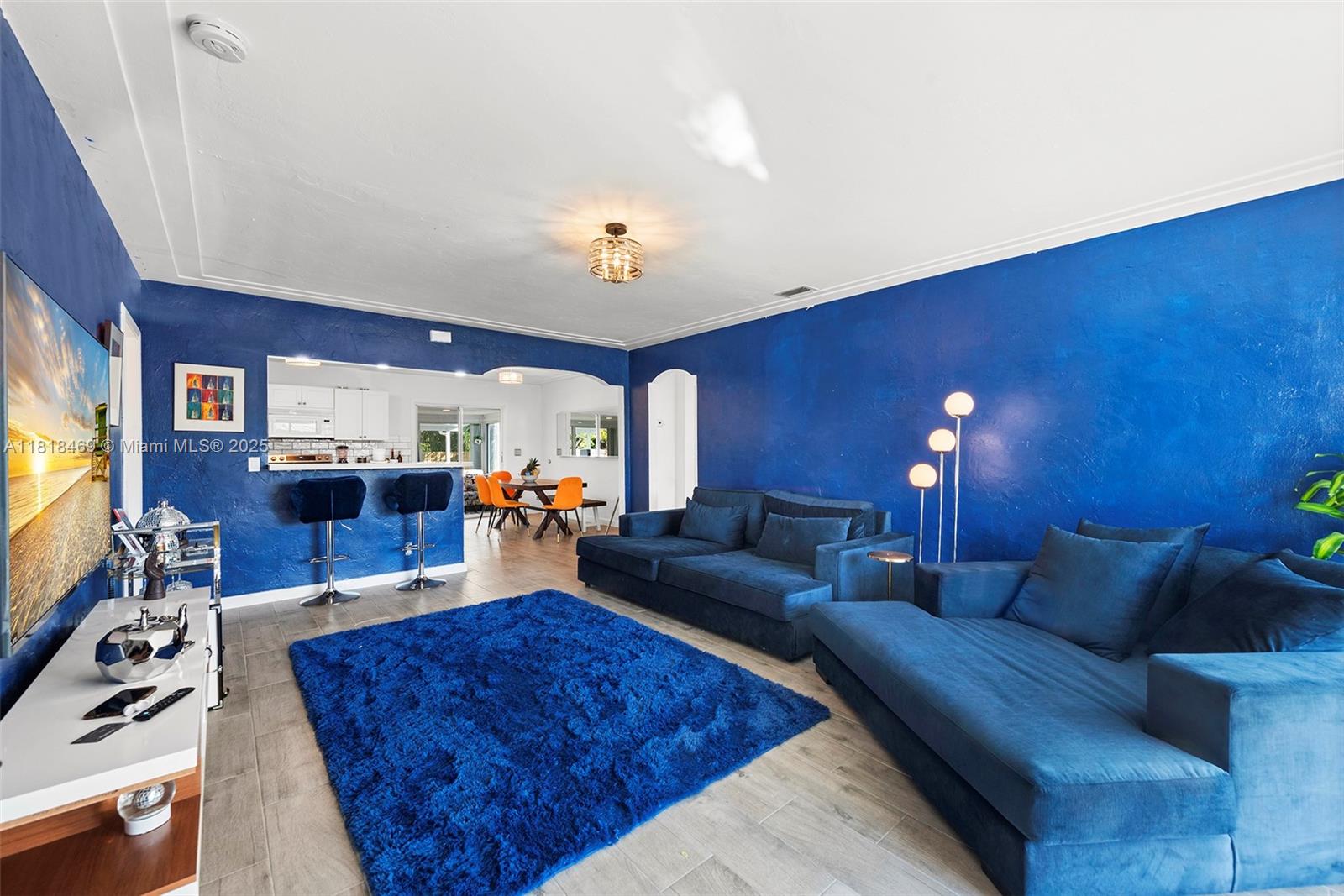 1545 Normandy Drive Miami Beach, FL 33141 - Photo 8 of 37 a living room with furniture and a flat screen tv