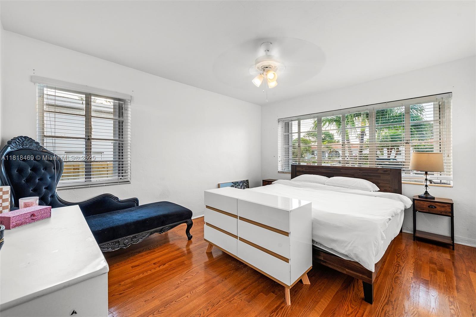 1545 Normandy Drive Miami Beach, FL 33141 - Photo 10 of 37 a bedroom with a bed and wooden floor