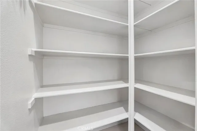 a kitchen with stainless steel appliances white cabinets and a refrigerator