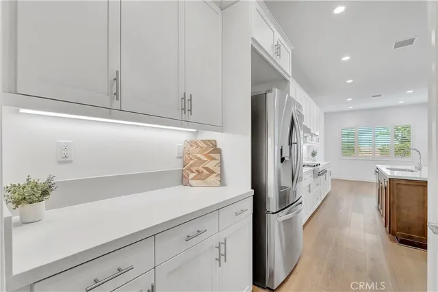 a kitchen with stainless steel appliances granite countertop a stove and a refrigerator