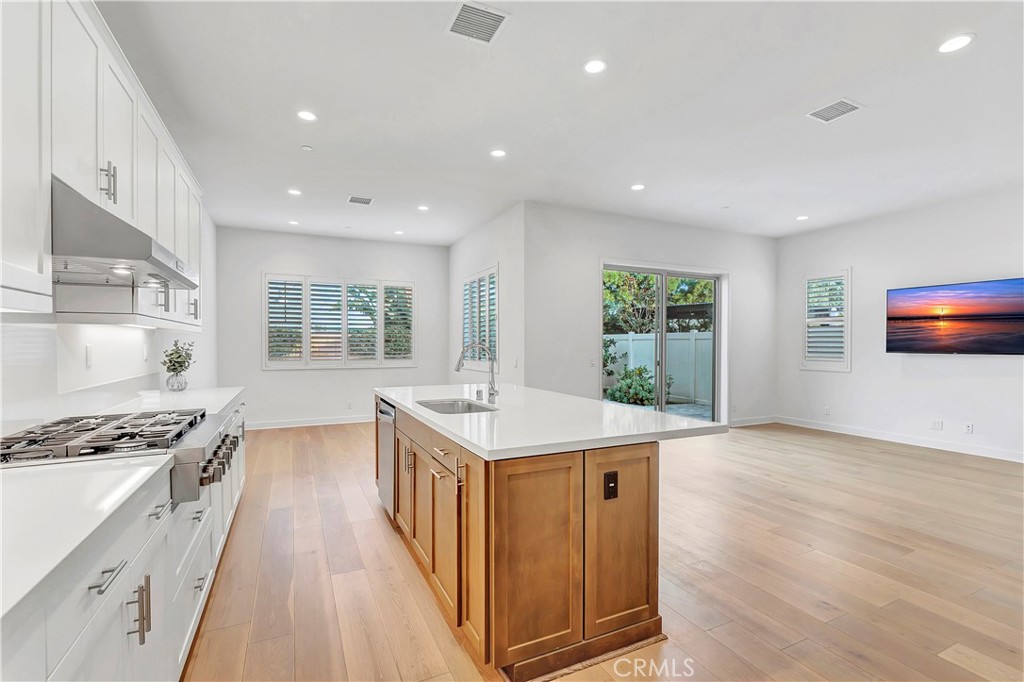 14432 Windfall Lane Huntington Beach, CA 92647 - Photo 13 of 62 a kitchen with stainless steel appliances granite countertop a stove and a refrigerator