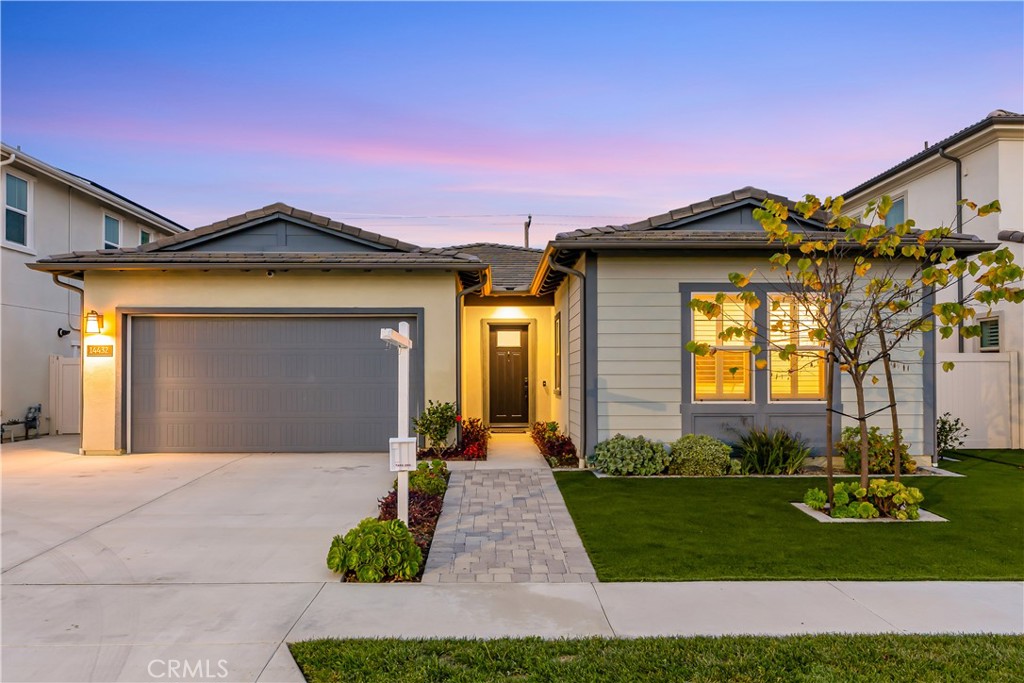 14432 Windfall Lane Huntington Beach, CA 92647 - Photo 2 of 62 a front view of a house with a yard and garage