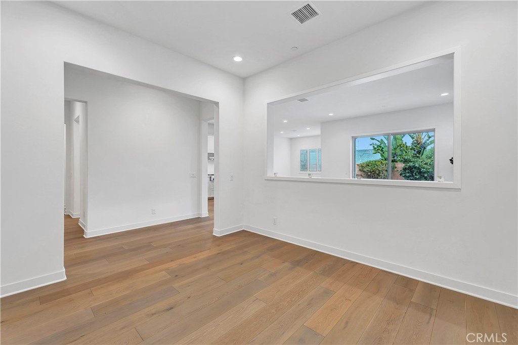 14432 Windfall Lane Huntington Beach, CA 92647 - Photo 23 of 62 an empty room with wooden floor and windows