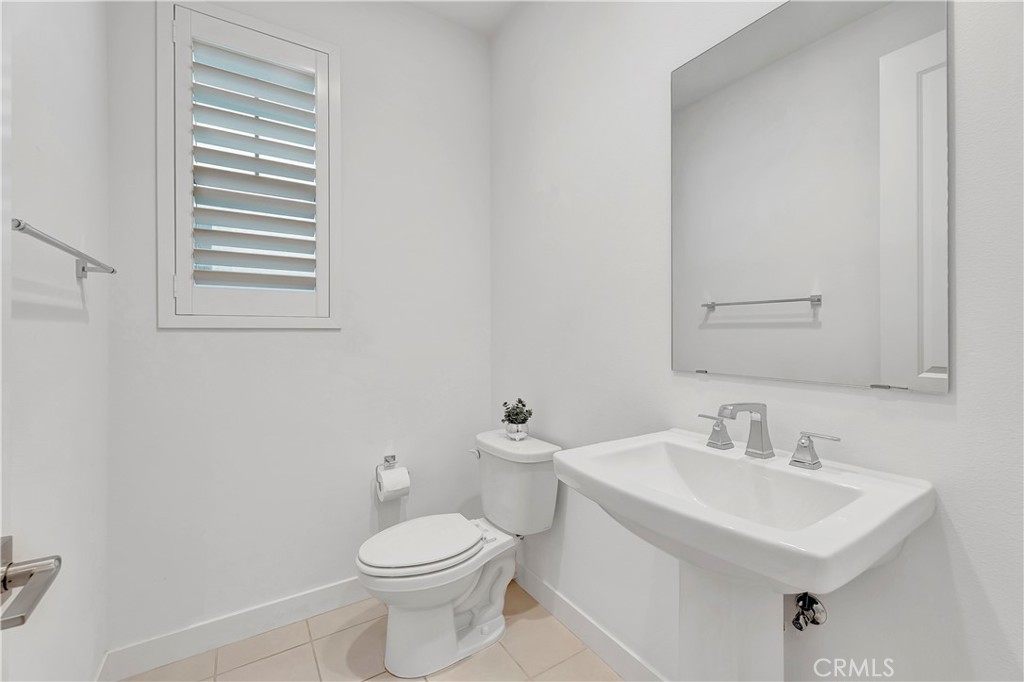 14432 Windfall Lane Huntington Beach, CA 92647 - Photo 25 of 62 a bathroom with a sink a toilet and mirror