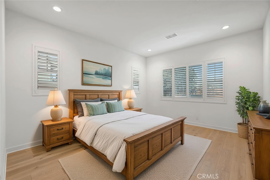14432 Windfall Lane Huntington Beach, CA 92647 - Photo 27 of 62 a bedroom with a large bed and a potted plant