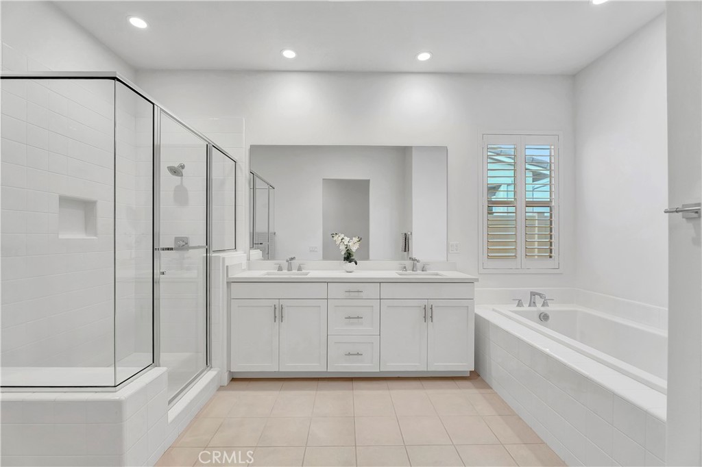 14432 Windfall Lane Huntington Beach, CA 92647 - Photo 31 of 62 a large bathroom with a tub sink shower and mirror