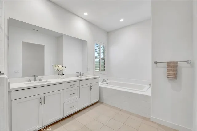 a bedroom with bed and a potted plant