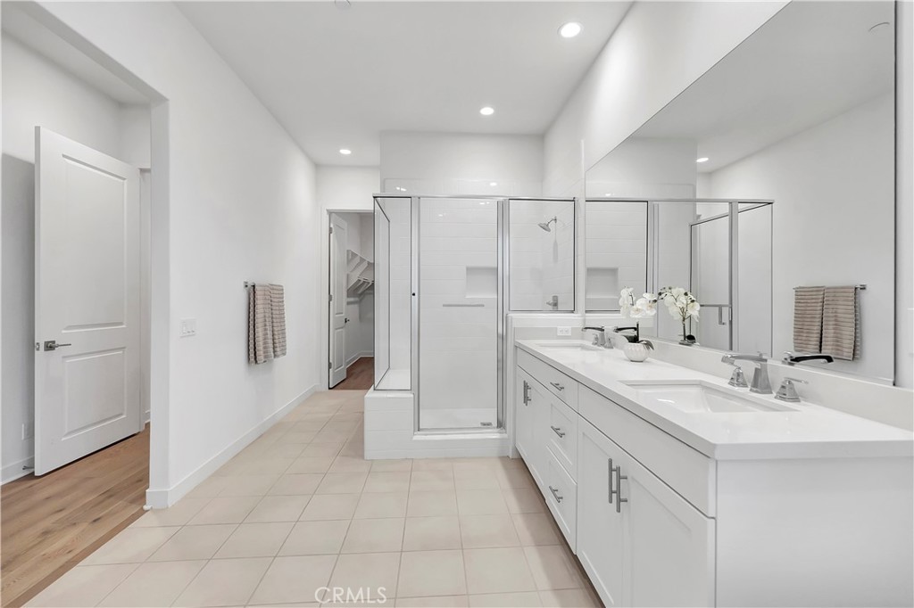 14432 Windfall Lane Huntington Beach, CA 92647 - Photo 33 of 62 a bathroom with a double vanity sink mirror and shower