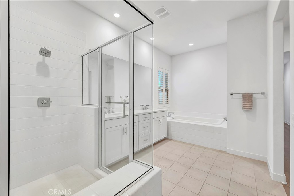 14432 Windfall Lane Huntington Beach, CA 92647 - Photo 34 of 62 a bathroom with a bathtub and a shower