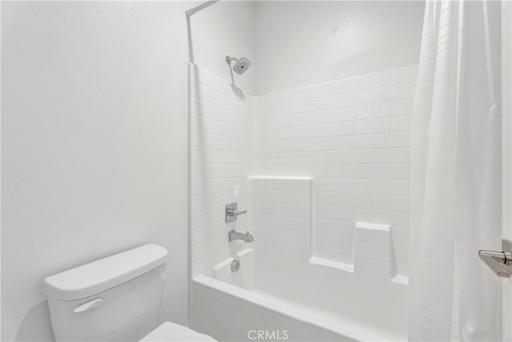 14432 Windfall Lane Huntington Beach, CA 92647 - Photo 41 of 62 a bathroom with a bathtub and a toilet