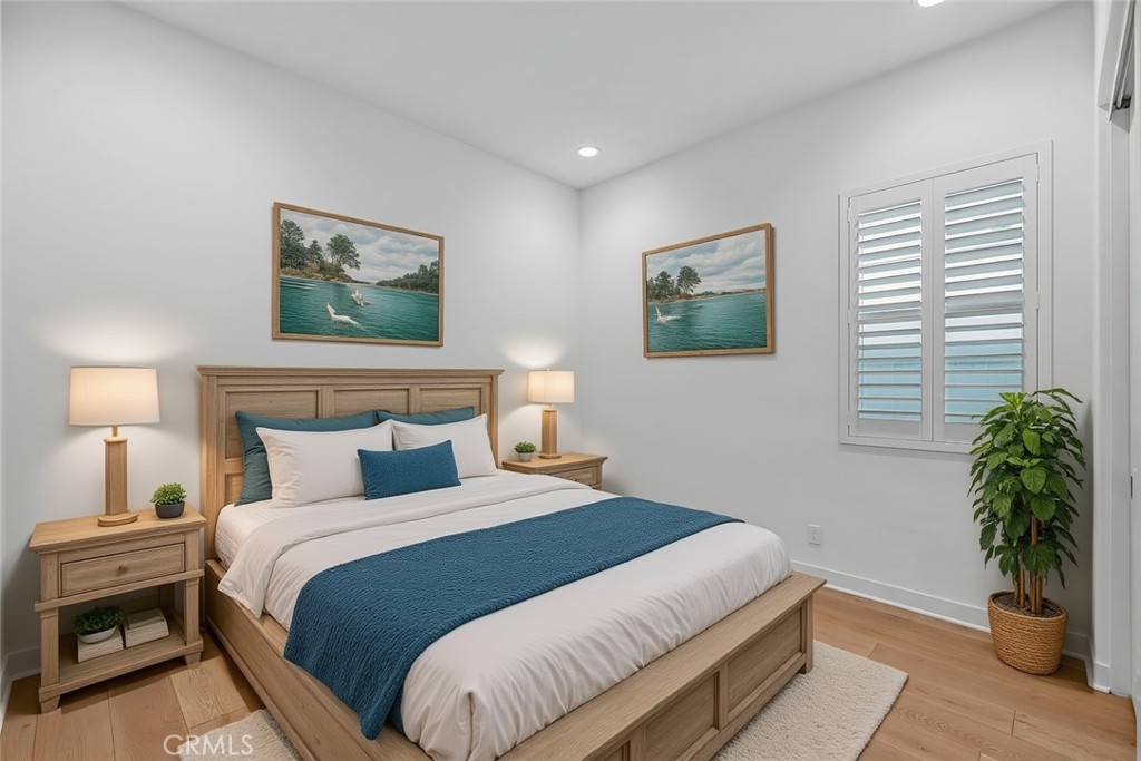 14432 Windfall Lane Huntington Beach, CA 92647 - Photo 42 of 62 a bedroom with bed and a potted plant