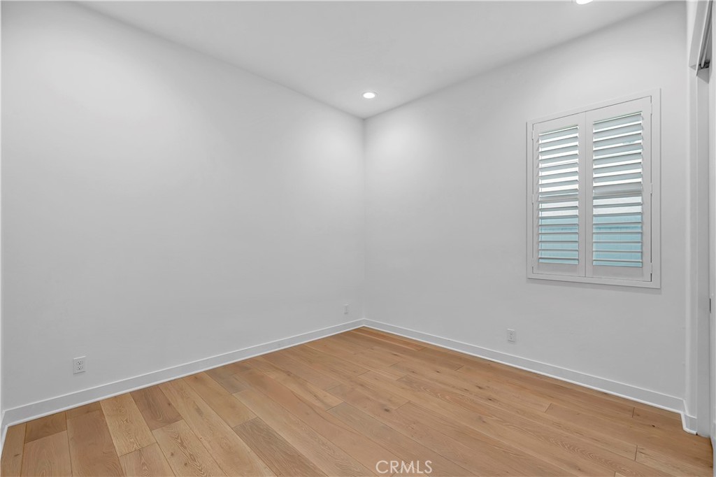 14432 Windfall Lane Huntington Beach, CA 92647 - Photo 43 of 62 a view of an empty room with wooden floor and a window