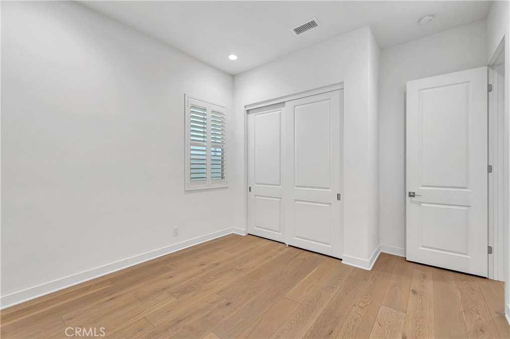 14432 Windfall Lane Huntington Beach, CA 92647 - Photo 44 of 62 a view of an empty room with wooden floor and closet