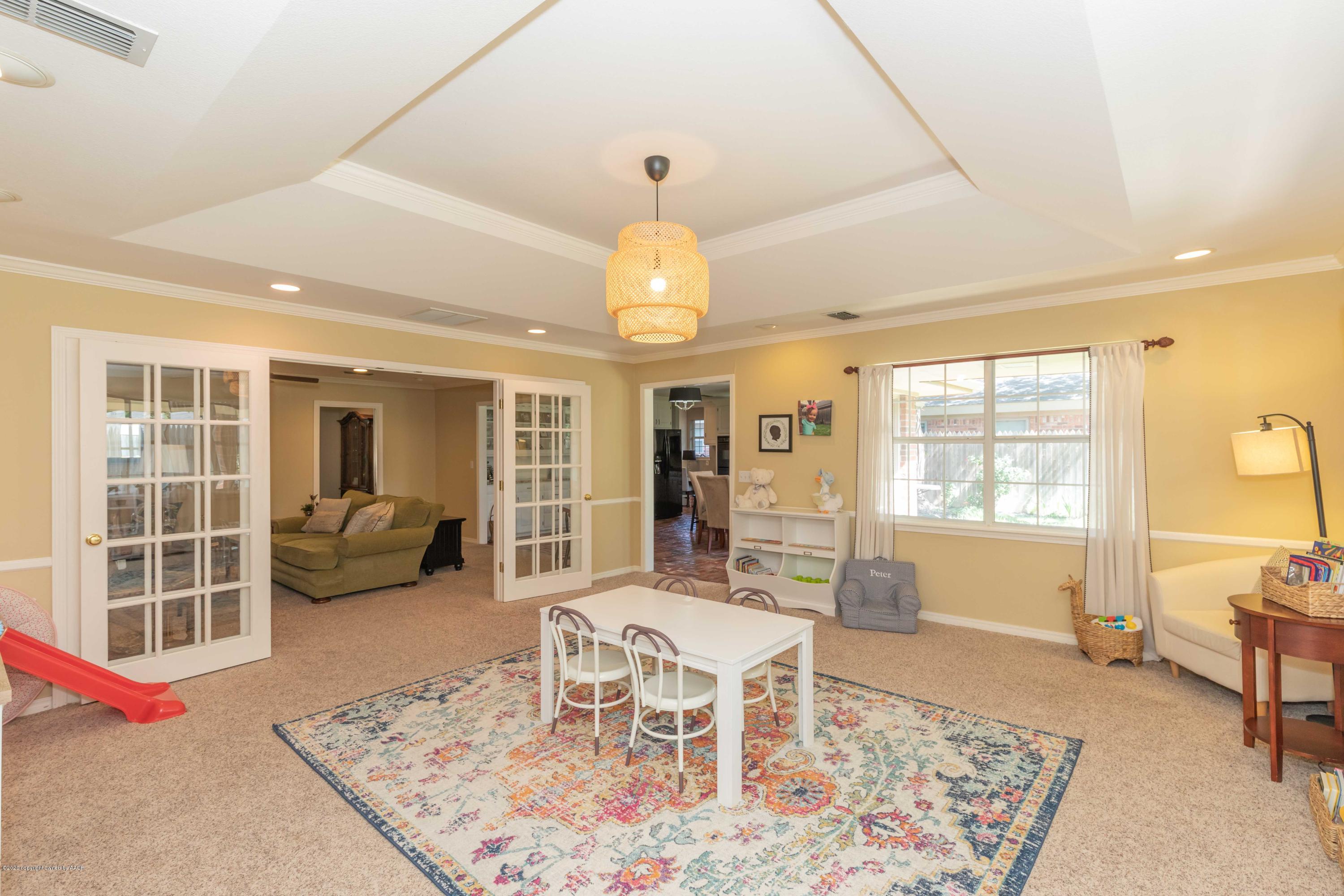 3307 Bedford Road Amarillo, TX 79106 - Photo 15 of 45 a dining room with wooden floor and a chandelier