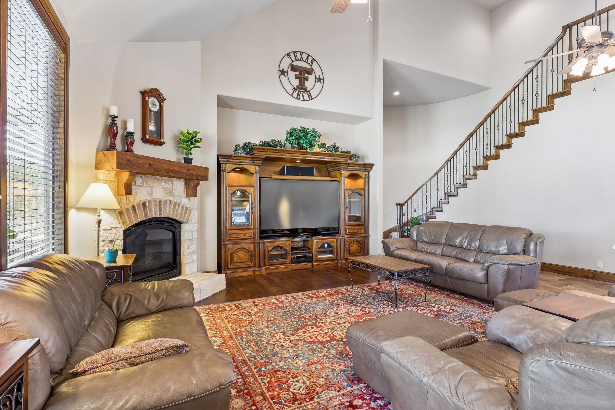 438 Patricia Road Georgetown, TX 78628 - Photo 8 of 36 Large living room w/ natural light, featuring gas fireplace & stone hearth.