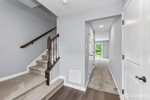 a view of entryway and hall with wooden floor