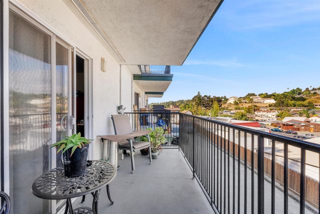 a view of a balcony with chairs