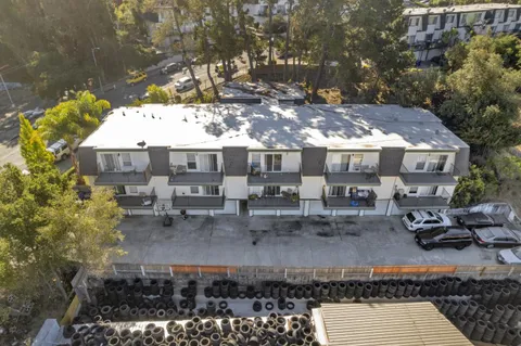 a view of a patio with table and chairs with wooden floor and plants