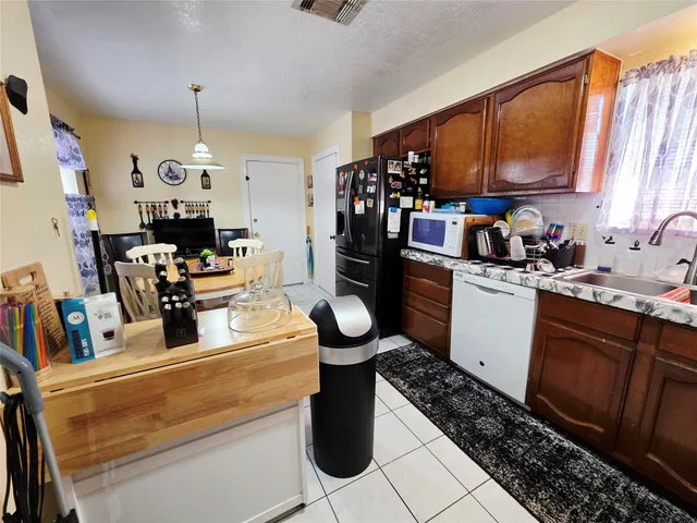 a kitchen filled with stainless steel appliances kitchen island granite countertop a stove and cabinets