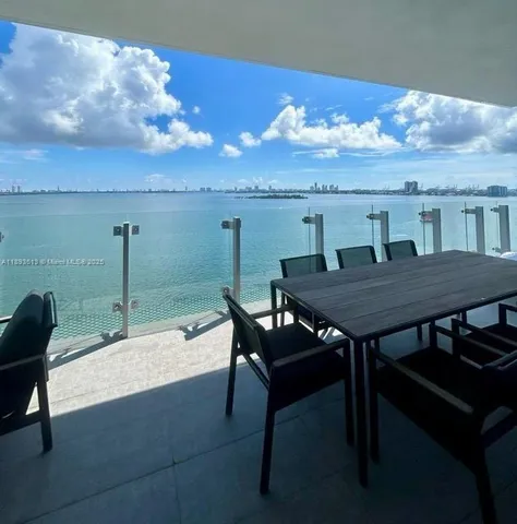a roof deck with table and chairs