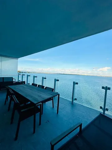 a view of a room with furniture and wooden floor