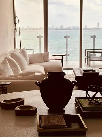 a living room with furniture and a floor to ceiling window