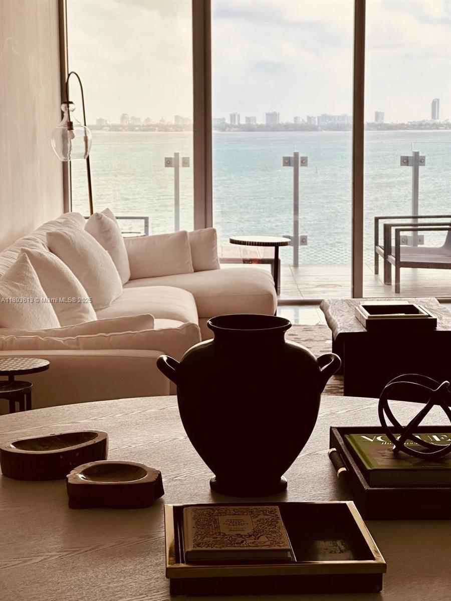 700 Northeast 26th Terrace, Unit 803 Miami, FL 33137 - Photo 3 of 13 a living room with furniture and a floor to ceiling window